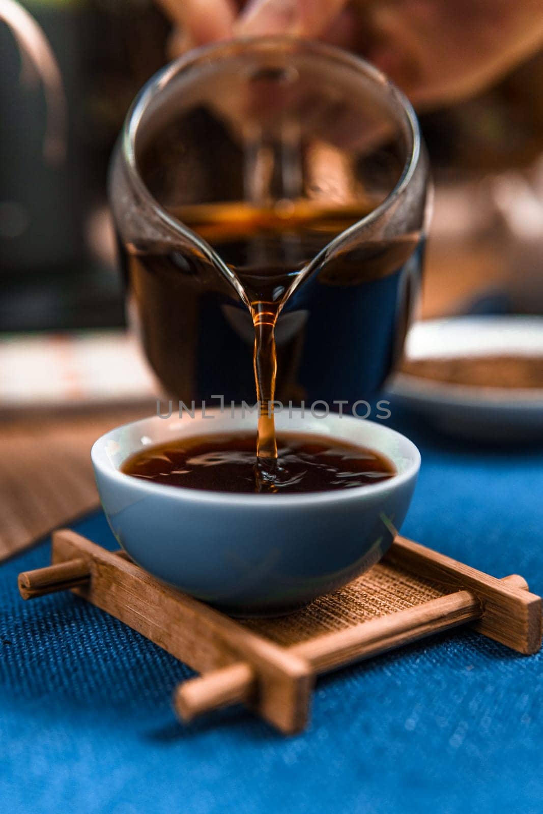 A closeup of steaming coffee being poured into a cup, showcasing its rich color and the brewing process