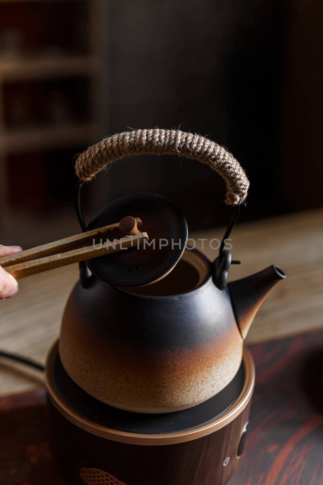 A beautifully crafted Japanese teapot elegantly displayed in use, showcasing the rich traditional tea culture