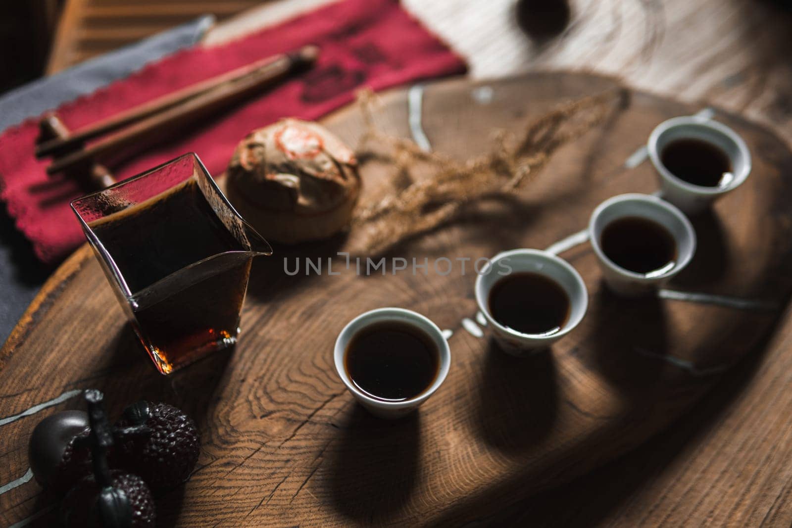 A warm and inviting tea setup displaying beautiful artisan cups and a charming teapot on a rustic wooden tray