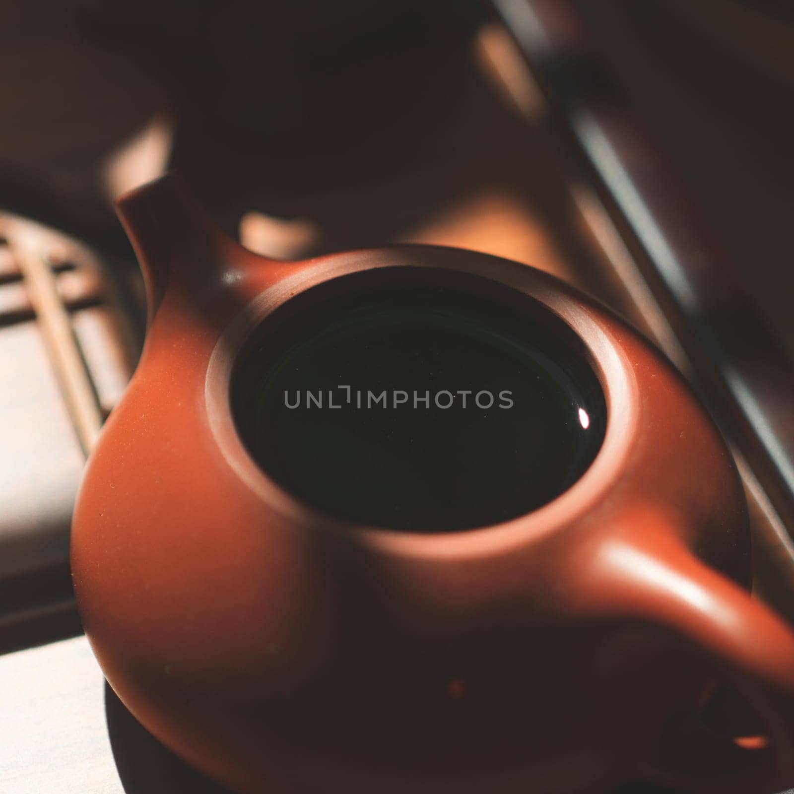 A beautifully serene teapot showcased in soft, warm light, making it ideal for tea lovers and cozy moments to enjoy