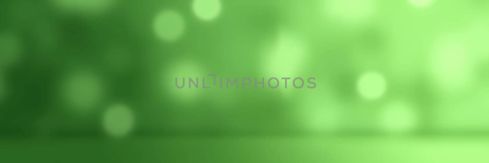 Soft green tones blend together to create a calming and vibrant abstract background. The bokeh effect adds depth and interest, perfect for design use.