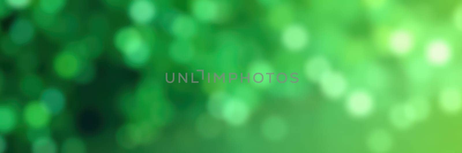 Vivid green bokeh lights shimmer softly in the background, enhancing the lively ambiance of a warm afternoon in a natural outdoor location surrounded by greenery.