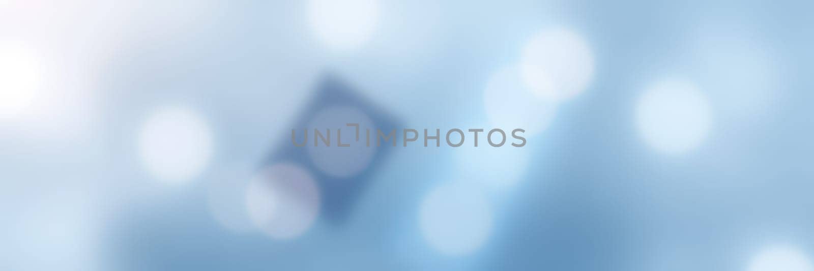 Soft blue background filled with light bokeh effects and abstract shapes. This design creates a calm and tranquil atmosphere, suitable for various digital projects or presentations.