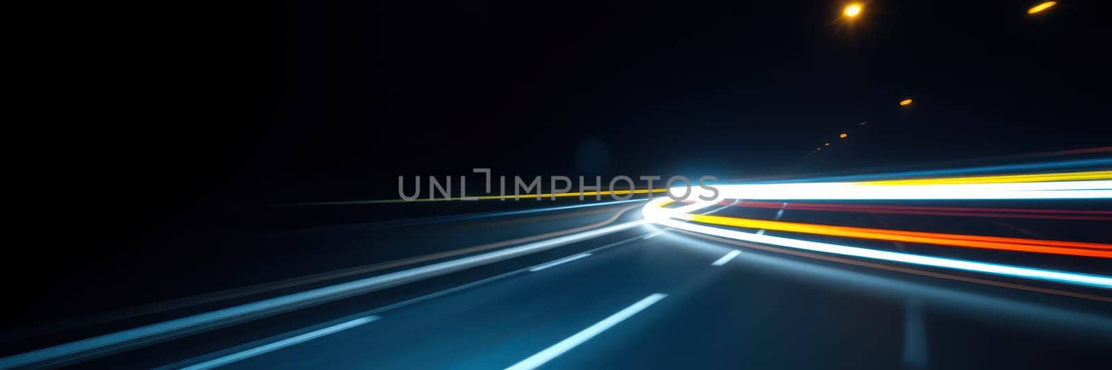 Bright trails of light from moving vehicles create a vibrant display along a dark highway, showcasing a busy night drive on an urban road.