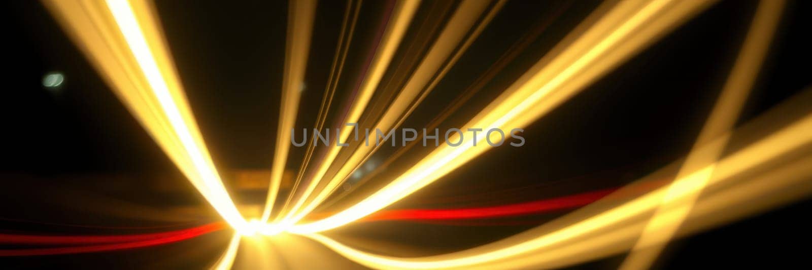 Light streaks illuminate the dark surroundings as vehicles move quickly along a bustling city road at night, creating a dynamic visual effect and an energetic atmosphere.
