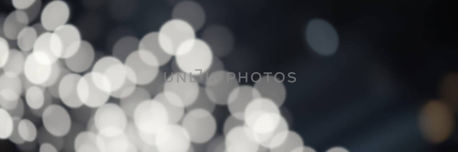 Soft light reflections dance across a dark surface, forming a mesmerizing abstract pattern. This enchanting visual evokes a sense of calm and intrigue in a nighttime environment.
