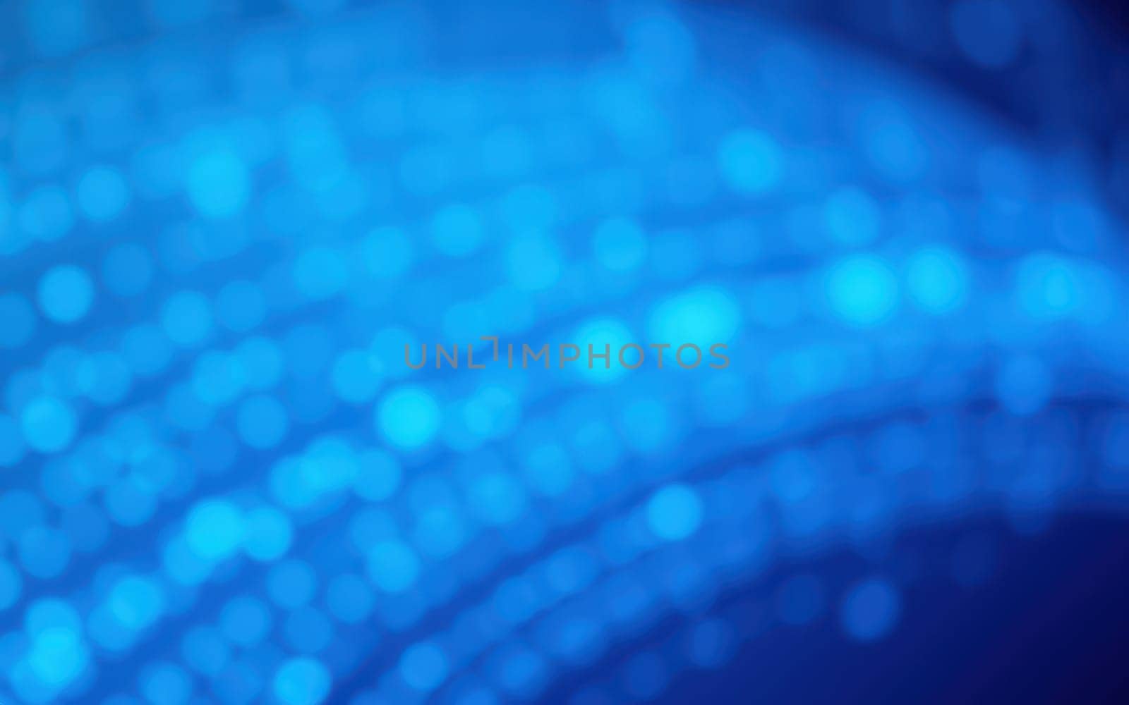 A swirl of bright blue bokeh lights forms an enchanting abstract background, creating a mesmerizing effect full of depth and shimmer. This scene evokes tranquility and creativity.