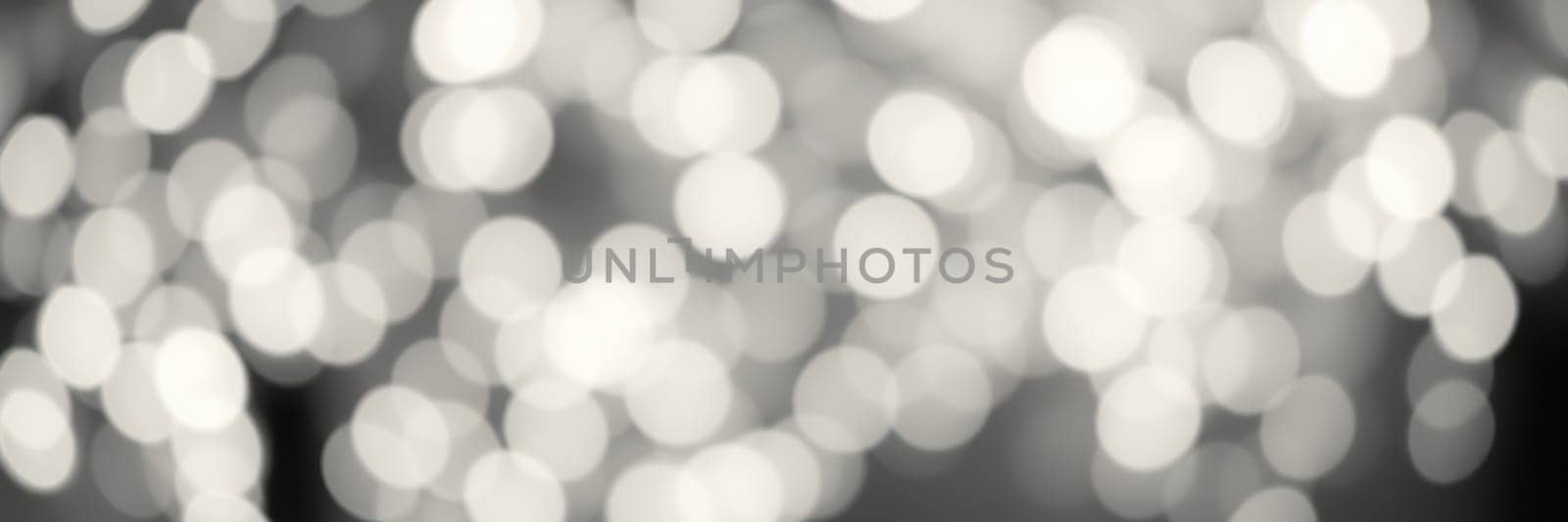 A beautiful display of soft bokeh lights fills the frame, creating a warm and enchanting ambiance at an outdoor gathering in the evening, perfect for socializing.