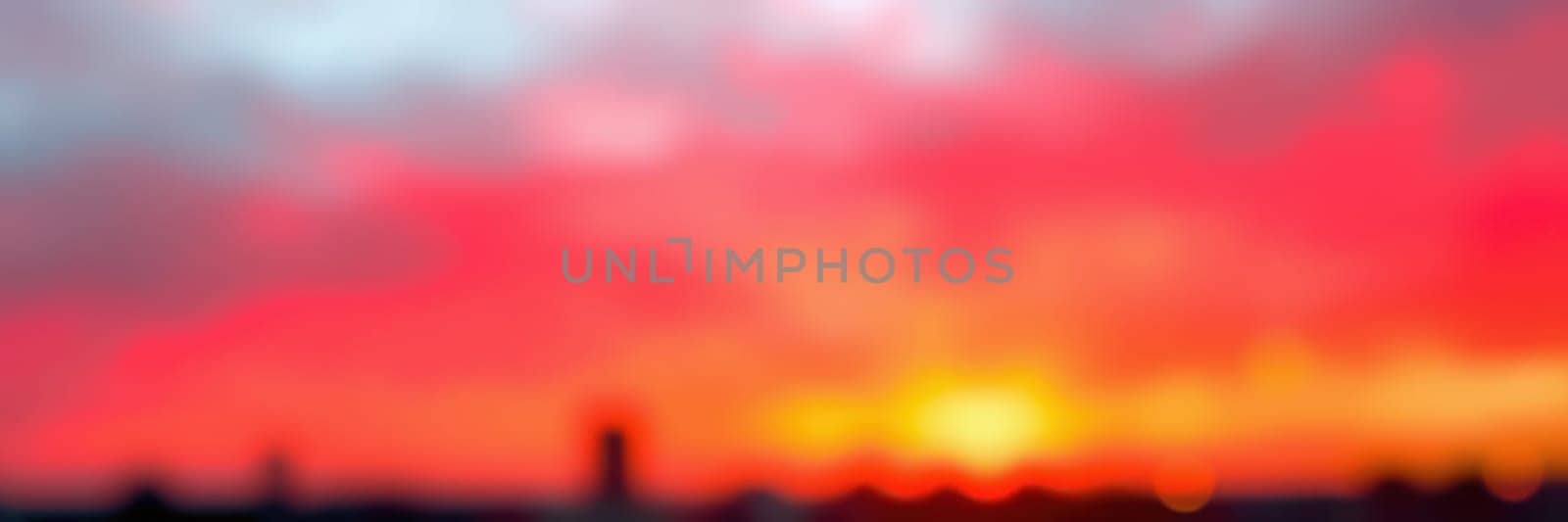 The skyline glows with a breathtaking sunset that paints the sky in shades of red, orange, and pink, evoking a serene and enchanting moment in the evening.