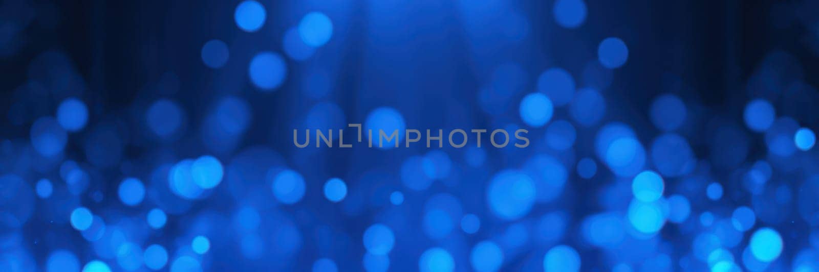 Soft blue bokeh lights fill the background with a radiant glow, creating an enchanting atmosphere perfect for creative designs and artistic projects. The sparkling orbs add depth and elegance.