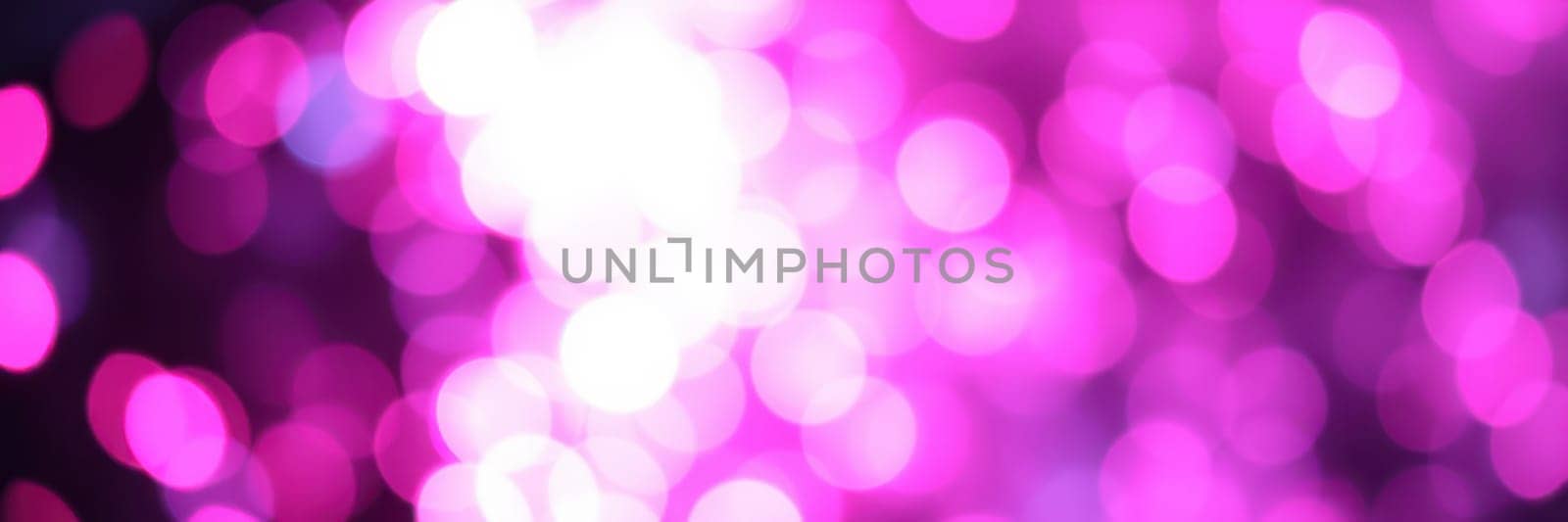 Vibrant bokeh lights in shades of pink illuminate a blurred background, creating a festive and enchanting ambiance ideal for parties or special occasions at nighttime.