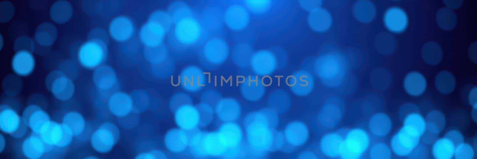 Soft, glowing blue orbs of light float against a dark background, forming a captivating bokeh effect. This design adds depth and enhances the visual experience.