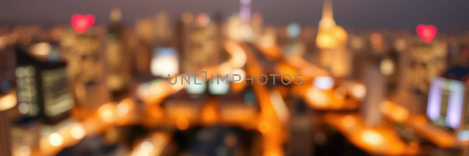 A city skyline comes alive at night, showcasing dazzling lights that reflect the energetic atmosphere of urban life. Architectural landmarks stand out against the dark sky.