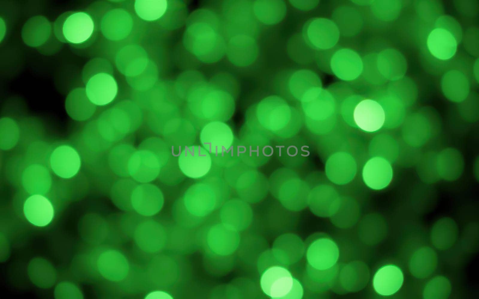 A dazzling array of green bokeh lights fills the space, creating a magical ambiance for an evening gathering. The bright dots of light add a sense of celebration and joy.