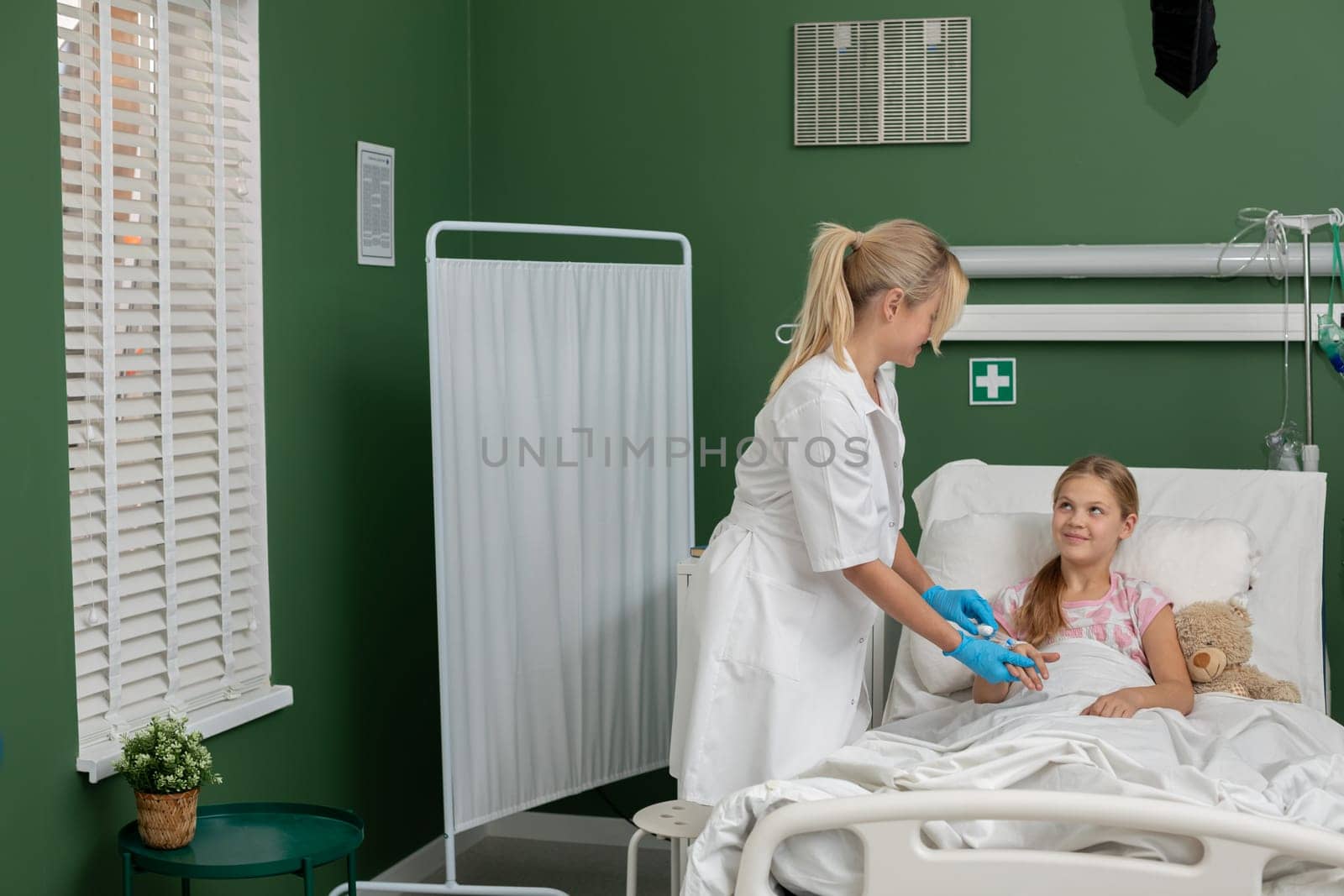 In a bright and cheerful hospital environment, a dedicated nurse attentively provides care to a young patient