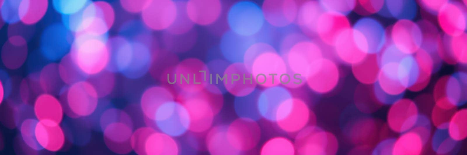 A vibrant display of blurred lights in shades of pink, purple, and blue fills the background, evoking a lively and festive ambiance perfect for an evening event.
