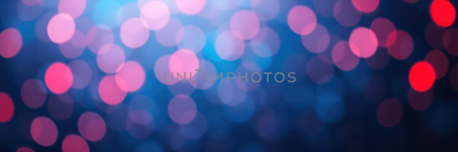 Brightly colored bokeh lights in pink and blue create a magical ambiance during an evening gathering, highlighting the festive atmosphere and joyful spirit of the occasion.
