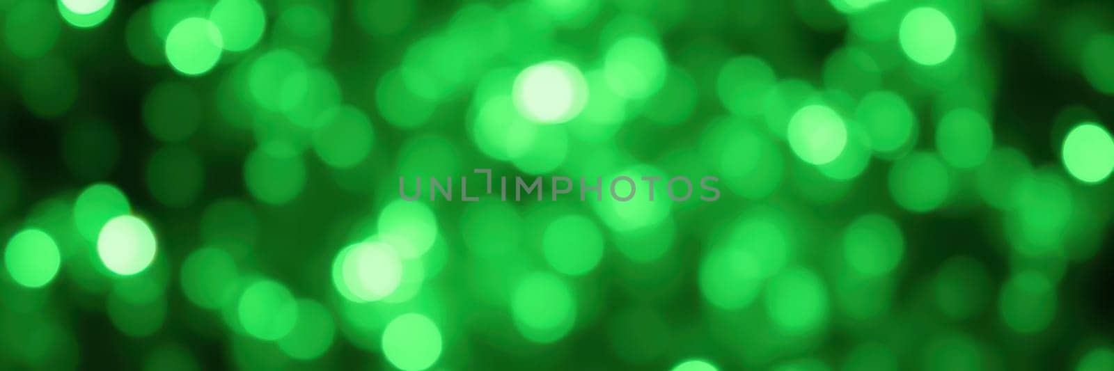 A dazzling display of bright green light creates a bokeh effect, offering a lively and festive atmosphere ideal for celebrations and gatherings. The shimmering light adds a magical touch.