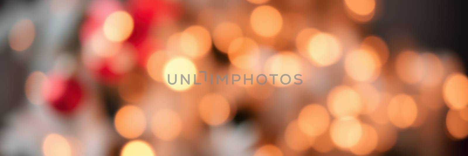 Soft, glowing lights shimmer in a blurred background, evoking a warm holiday spirit in a cozy indoor space during winter festivities.