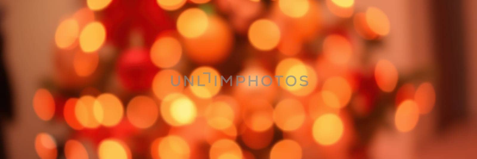 Colorful lights sparkle throughout a decorated tree, creating a festive ambiance perfect for winter celebrations. The soft glow adds warmth to the holiday spirit.