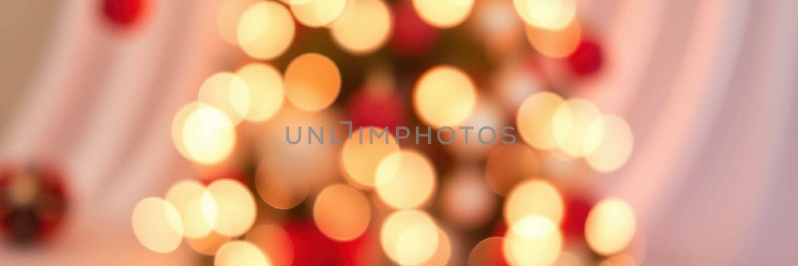 A vibrant Christmas tree glows with warm lights and colorful ornaments, bringing a cozy and festive spirit to the surrounding space during the holiday season.