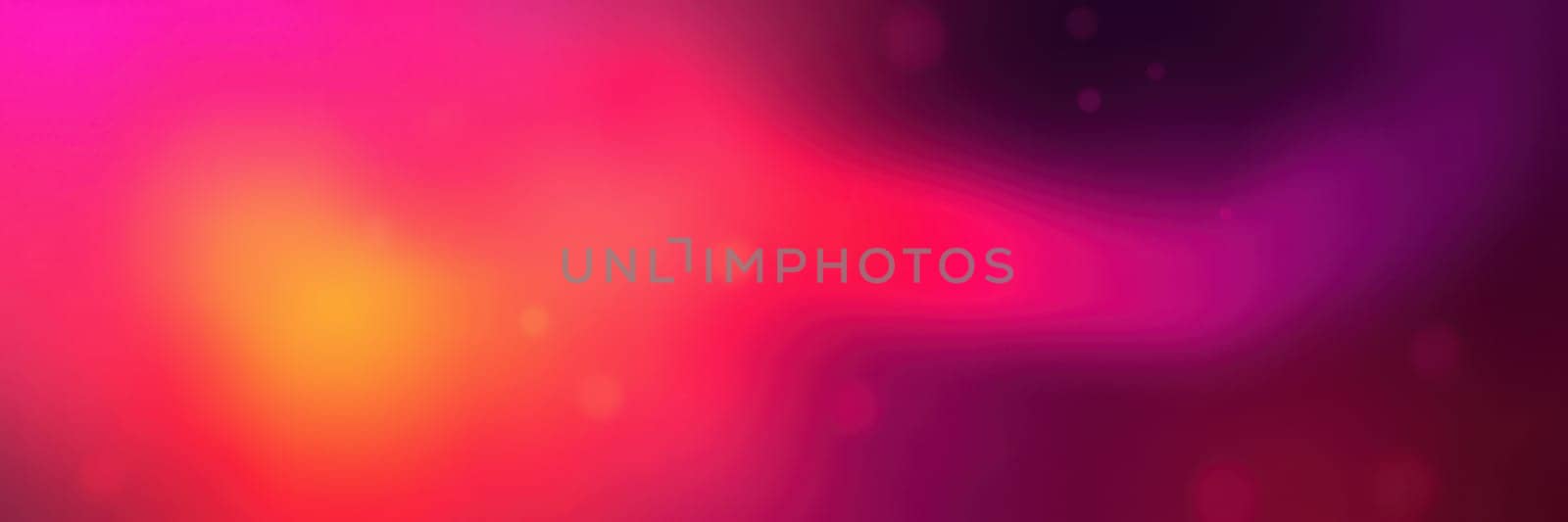 A rich blend of pink, purple, and orange colors merges to form an abstract background. The vibrant hues create a sense of movement and warmth, perfect for design purposes.