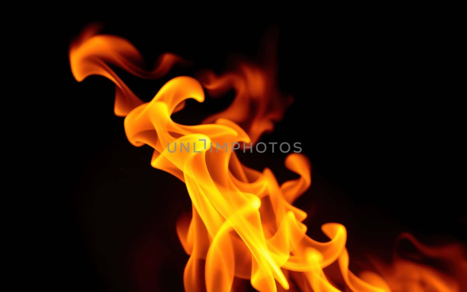 Flames flicker and twist gracefully in the darkness, illuminating the surroundings with a warm, golden hue. The fire radiates energy and warmth, captivating the viewer.