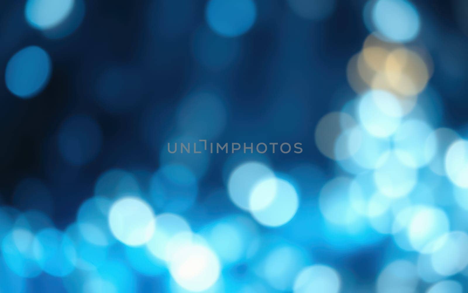 Soft blue lights blend together in a stunning bokeh effect, creating a calm and enchanting ambiance that captivates onlookers during the evening hours.
