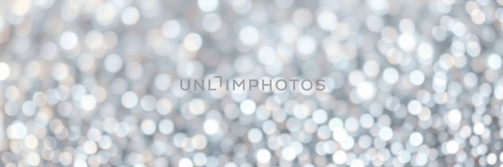 A shimmering background filled with soft silver bokeh creates an elegant and festive mood, perfect for holiday gatherings and celebrations of joy.