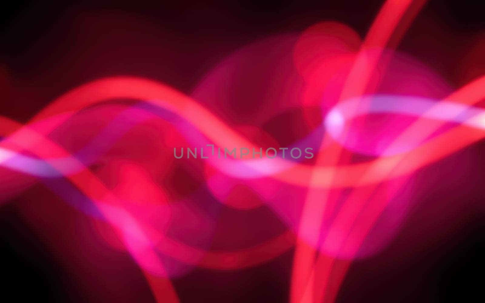 Colorful waves of light blend seamlessly over a dark background, showcasing a striking interplay of pink, purple, and blue hues. The luminous patterns create a dynamic visual experience.