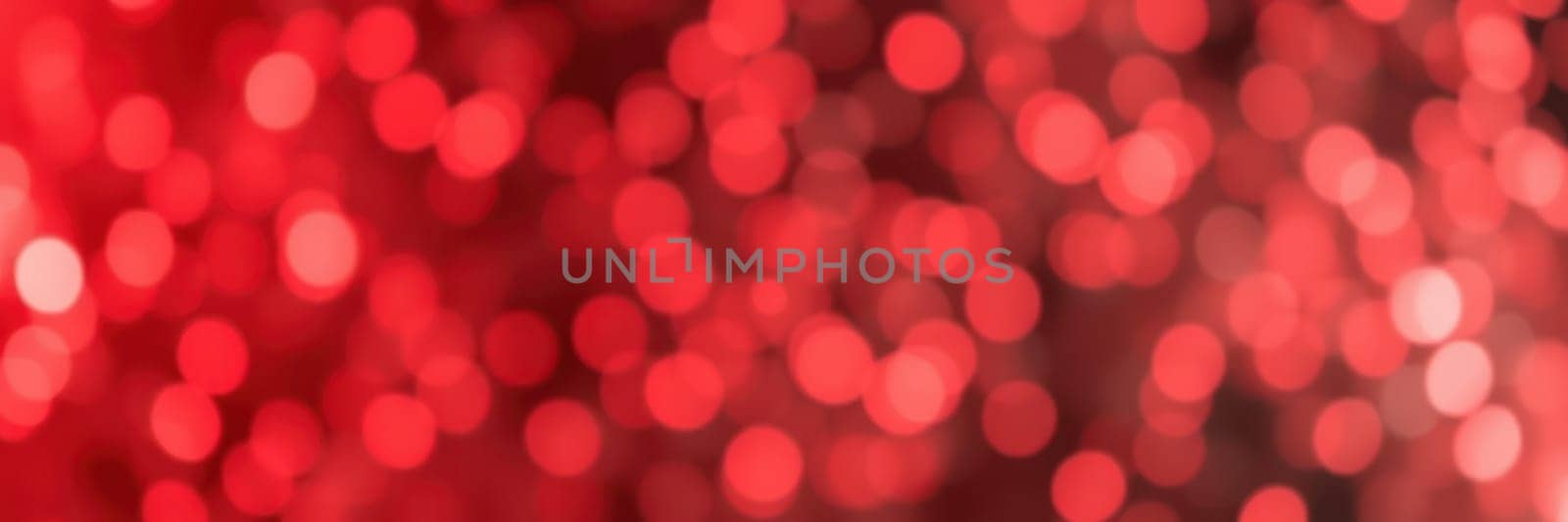 Soft red bokeh lights fill the background, creating a warm and inviting atmosphere perfect for evening festivities. The blurred effect adds depth, enhancing the festive mood.
