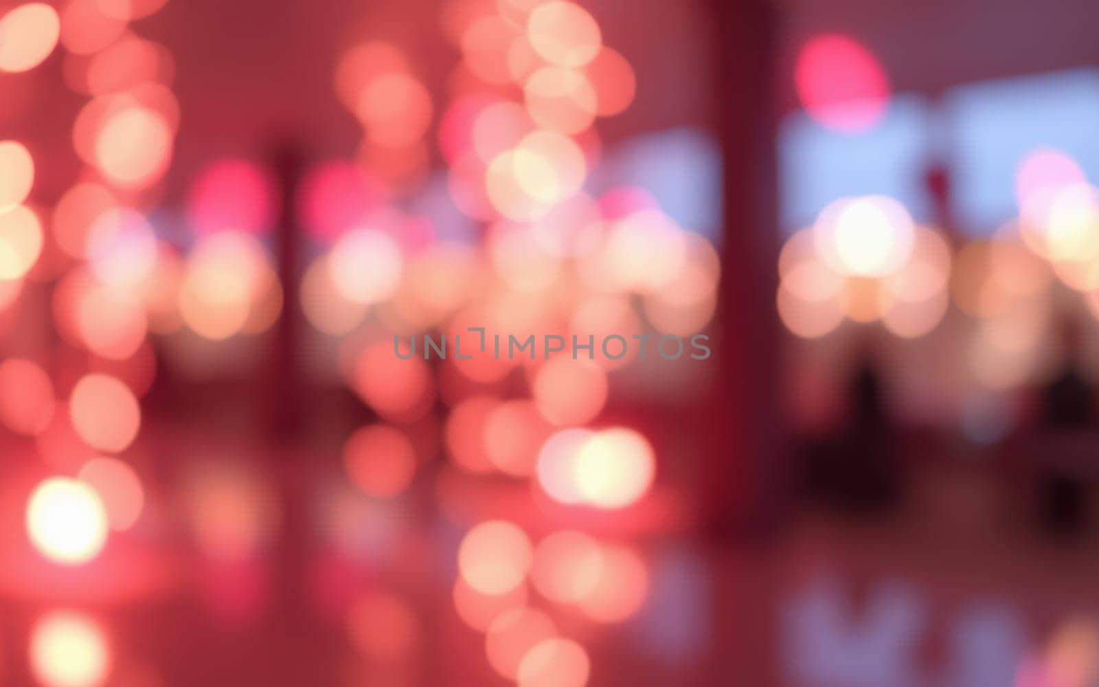 Soft, blurred glowing lights fill the space, creating a cozy ambiance for an evening gathering. The atmosphere is inviting and warm, perfect for celebration and socializing.
