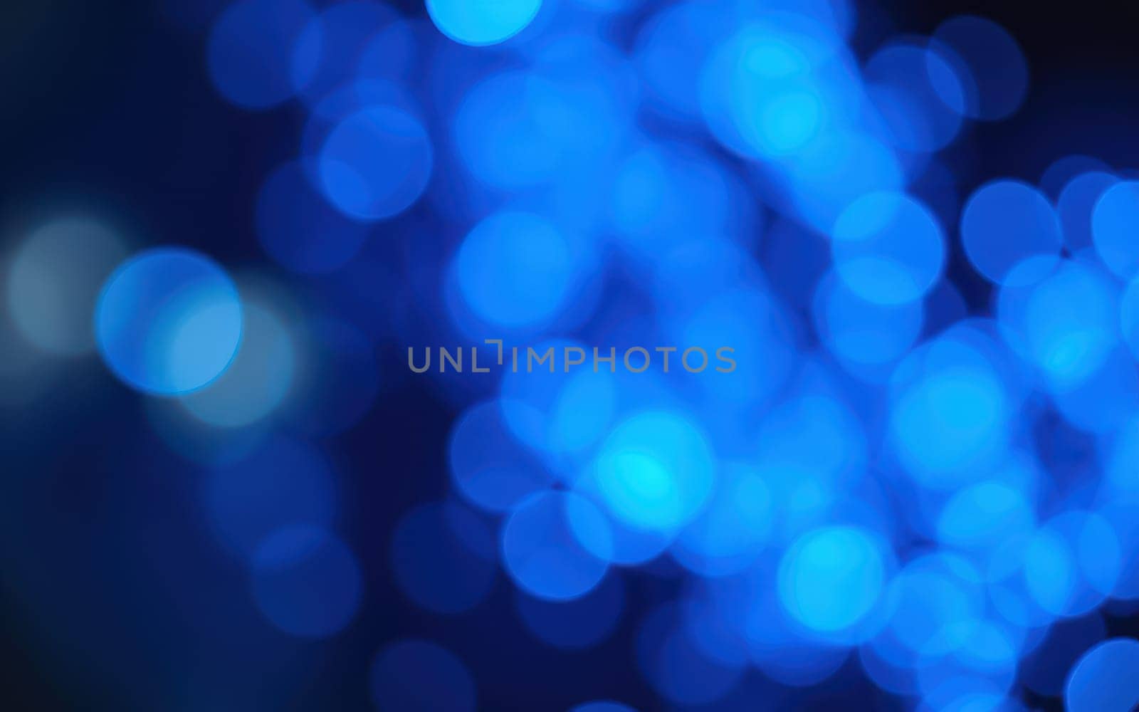 Soft, glowing blue lights fill the background, creating a dreamy and enchanting atmosphere. The blurred bokeh effect enhances the serene feel of the scene.