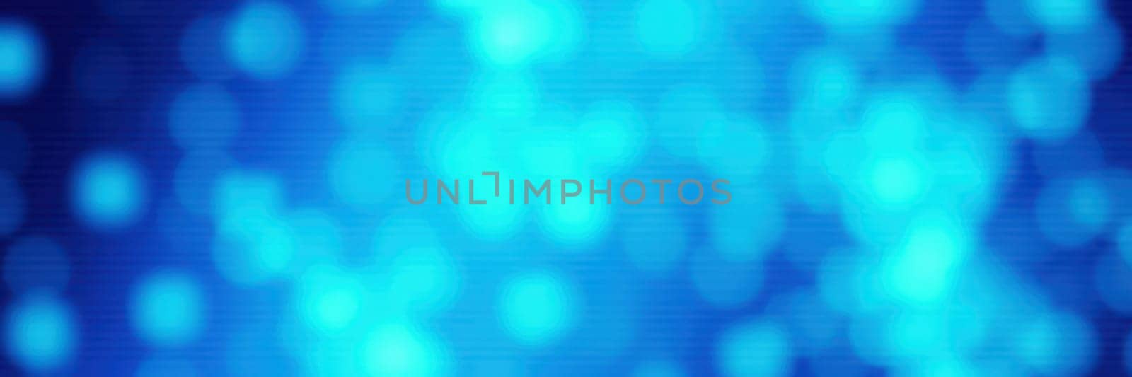 Vivid blue bokeh lights elegantly blur together, creating a serene and dreamy ambiance. The subtle variations in color capture the viewer's attention with their gentle glow.