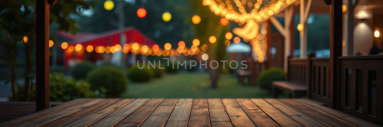 A cozy garden is beautifully illuminated by string lights hanging from trees. Colorful lanterns add charm, creating a warm ambiance for a festive gathering.