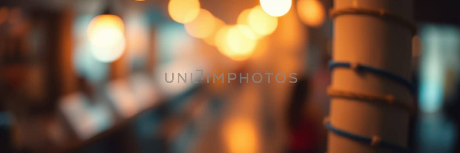 Soft golden lights shine down a bustling hallway filled with people. The atmosphere is vibrant, capturing the energy of the evening social event.