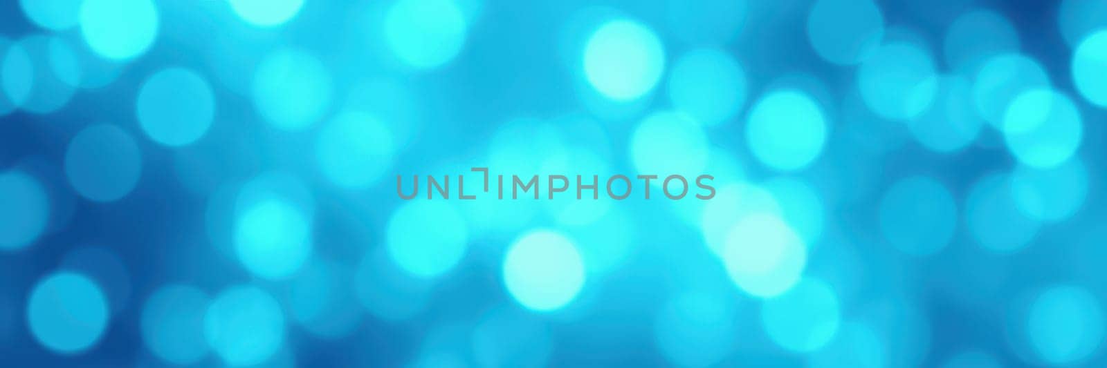 Soft blue lights form a beautiful bokeh effect, creating a serene and calming atmosphere ideal for relaxation or boosting creativity and inspiration, suitable for various settings.