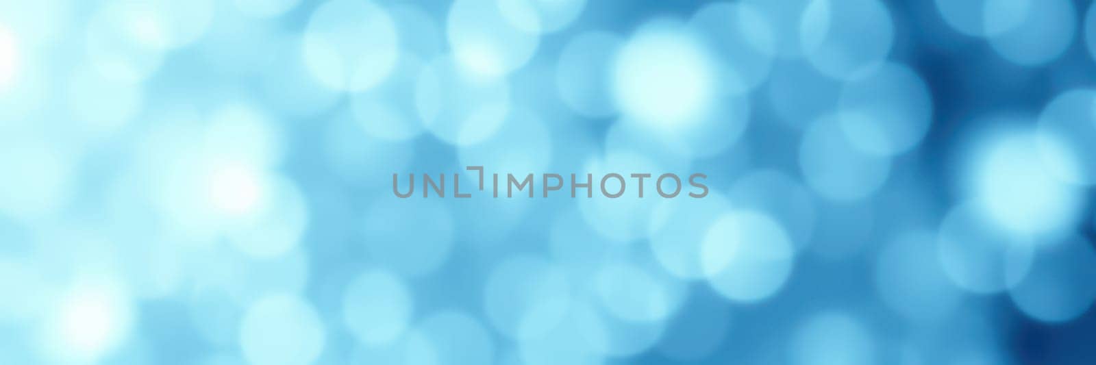 Soft blue circles of light create a tranquil background effect ideal for artistic projects. The blurred shapes enhance visual appeal, adding a serene touch to designs.