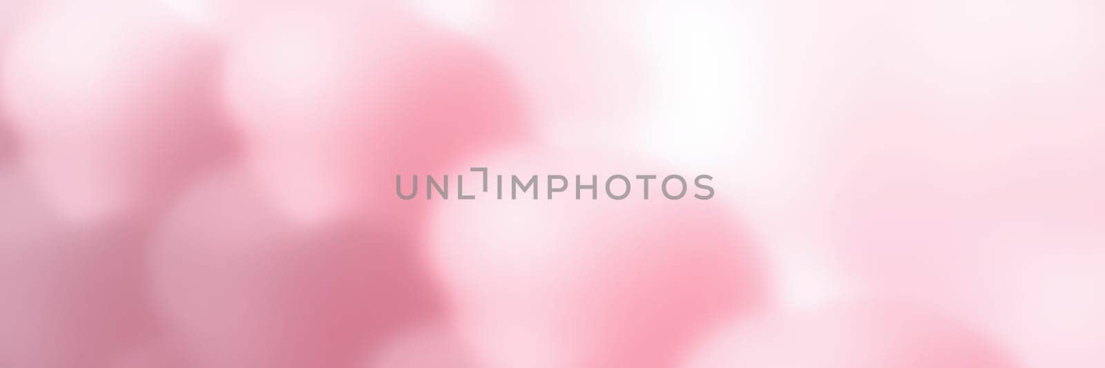 Delicate pink flowers bloom under warm sunlight, creating a serene atmosphere in a tranquil garden. Spring brings vibrant colors and refreshing scents to the surroundings.