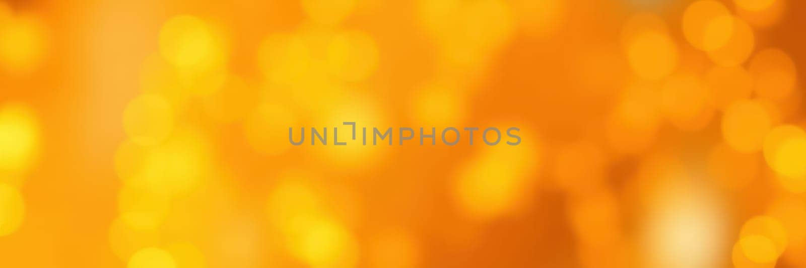 The warm glow of orange bokeh lights creates a cozy and festive atmosphere, perfect for an evening gathering. The soft, blurred lights evoke feelings of joy and celebration.