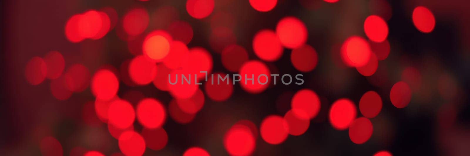 Strings of bright red lights fill the background, creating a cozy ambiance perfect for a joyful evening gathering or celebration with friends and family.