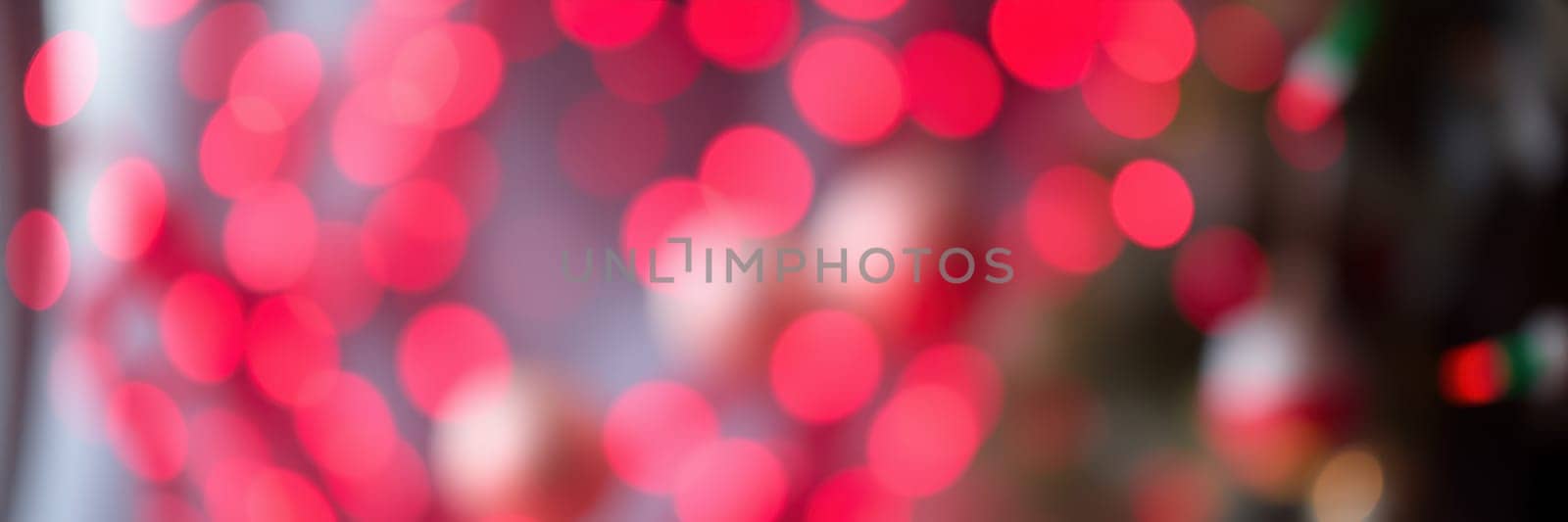 Bright red lights create a lively atmosphere at a festive event in the city center, drawing crowds to enjoy the cheerful environment and celebration.