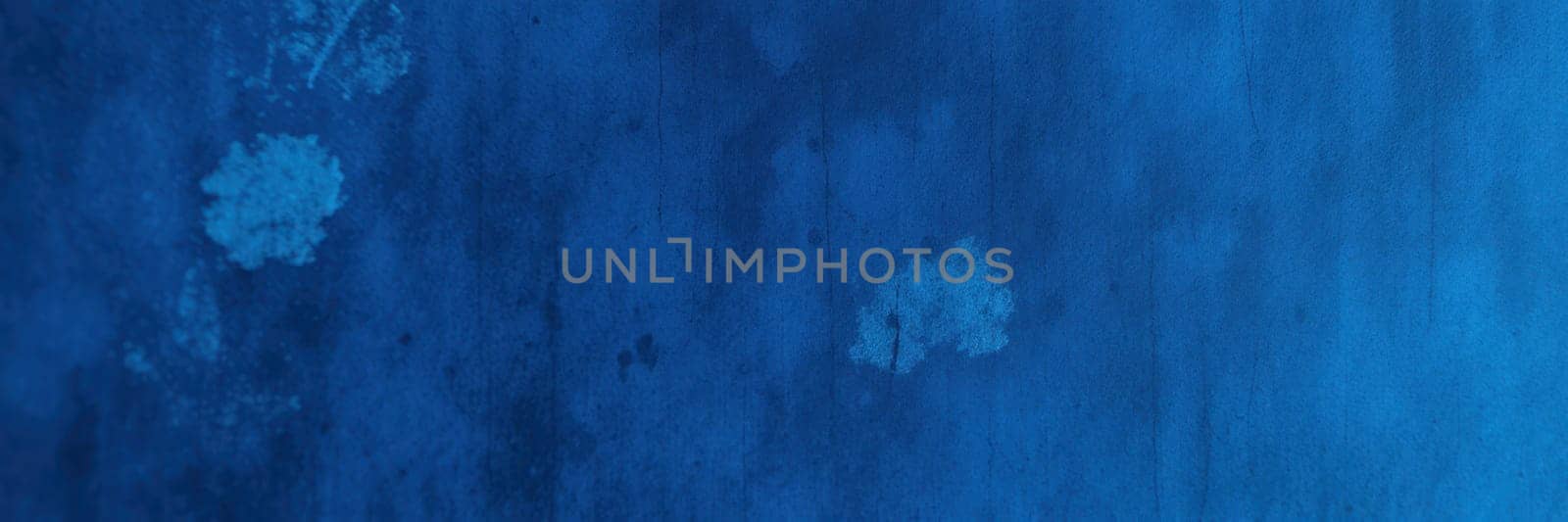 Deep blue colors blend seamlessly on the surface, showcasing rich textures and subtle variations that create a striking visual interest. The interplay of light adds depth to the design.