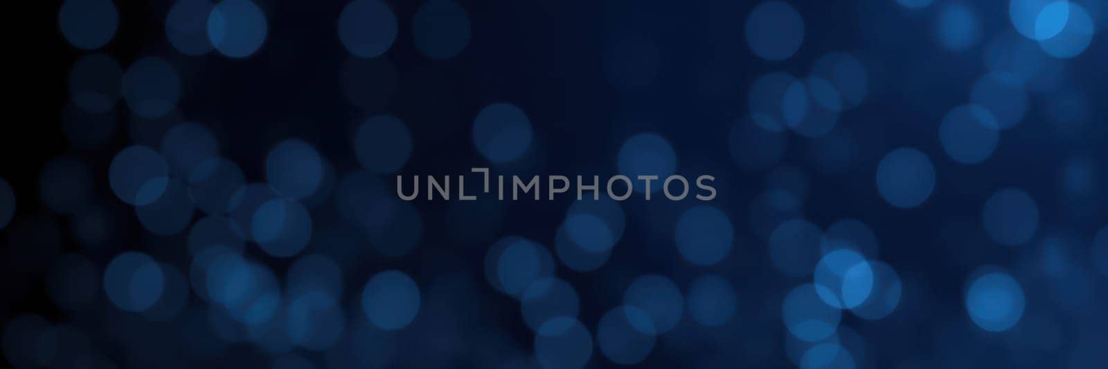 A captivating display of blue bokeh lights fills the dark background, creating a magical ambiance perfect for nighttime gatherings and celebrations. The soft glows provide a serene backdrop.