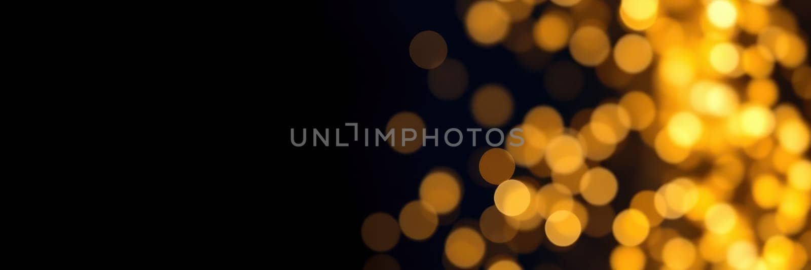 Golden bokeh lights shimmer against a dark backdrop, evoking a warm and inviting atmosphere. These vibrant lights enhance the festive mood during a nighttime celebration.