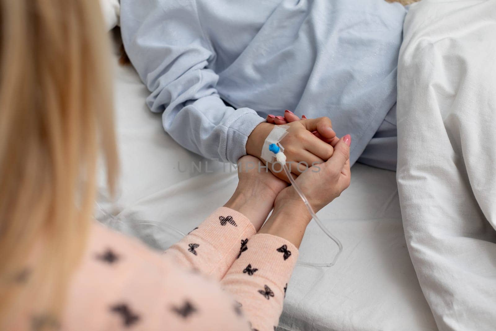 A deeply touching and heartfelt moment of support between close loved ones taking place in a hospital room