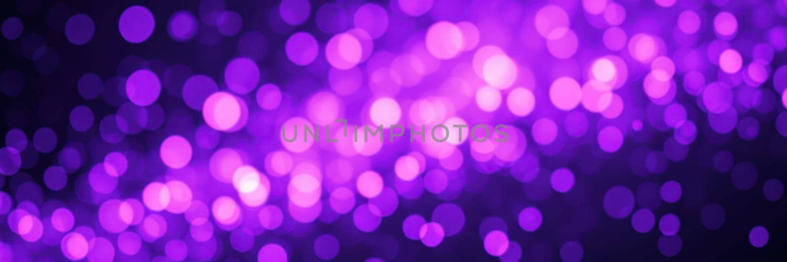 A stunning display of purple sparkling lights fills the background, enhancing the magical ambiance of a festive evening event. The vibrant colors captivate onlookers.