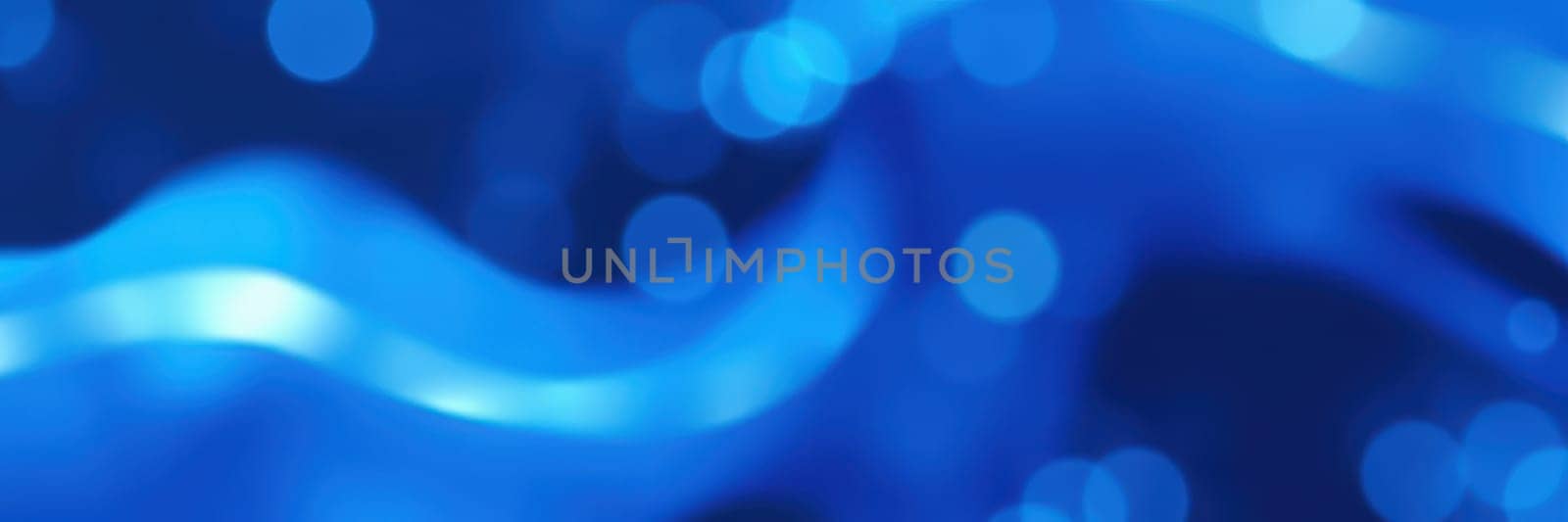 Gentle waves flow in shades of blue, creating a vibrant and dynamic visual effect. The interplay of light enhances the sense of movement and depth, evoking a tranquil atmosphere.