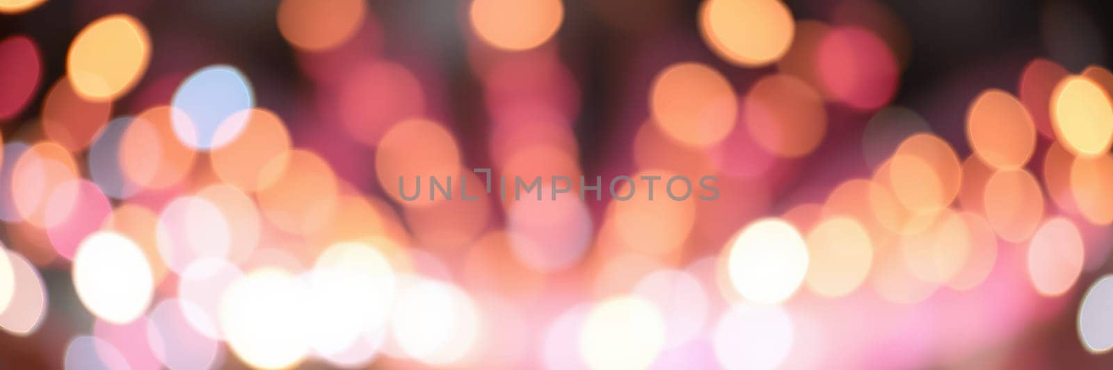 A dazzling display of colorful bokeh lights fills the background, adding a magical touch to the nighttime festivities and creating a cheerful ambiance.