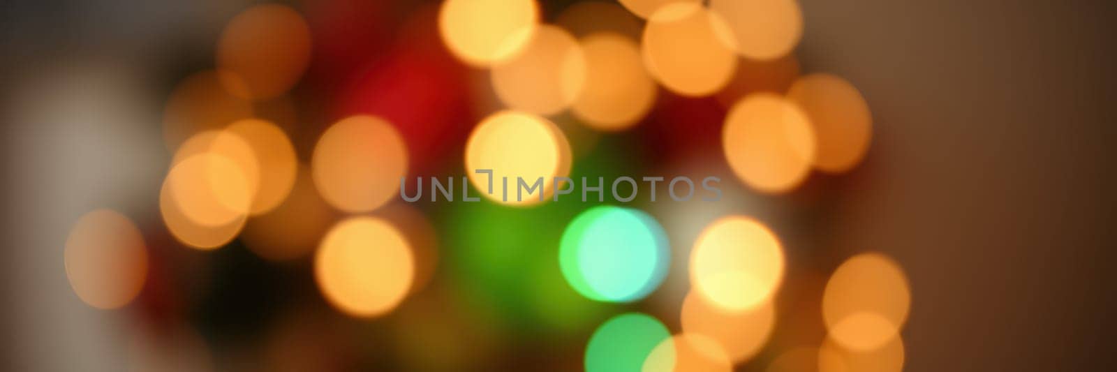 Soft, vivid bokeh effects from twinkling lights fill the space with warmth and cheer, enhancing the joyful ambiance of a winter gathering surrounded by colorful decorations.